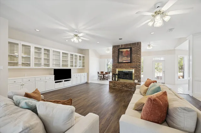 a living room with furniture fireplace and flat screen tv