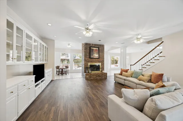 a living room with furniture wooden floor and a flat screen tv