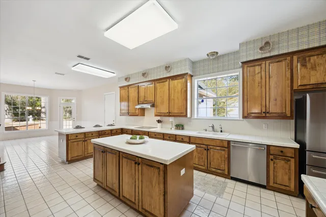 a kitchen with a stove sink and cabinets