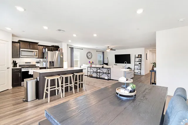 a kitchen with stainless steel appliances kitchen island granite countertop a sink and microwave