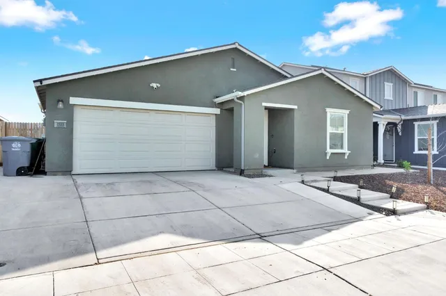 a front view of the house with garage