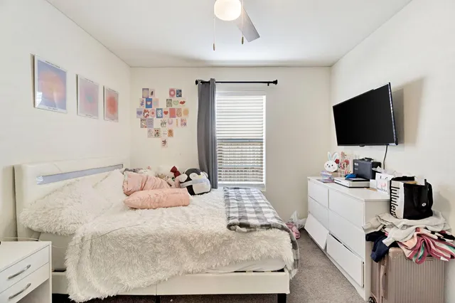 a bedroom with a bed and flat screen tv