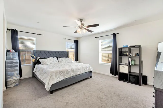 a bedroom with a bed dresser and a window