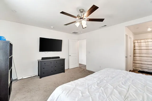 a bedroom with a bed and a flat screen tv