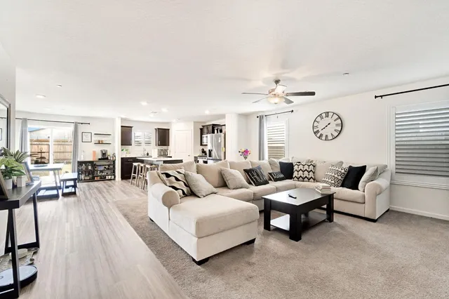 a living room with furniture and a large window