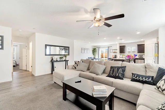 a living room with furniture and kitchen view