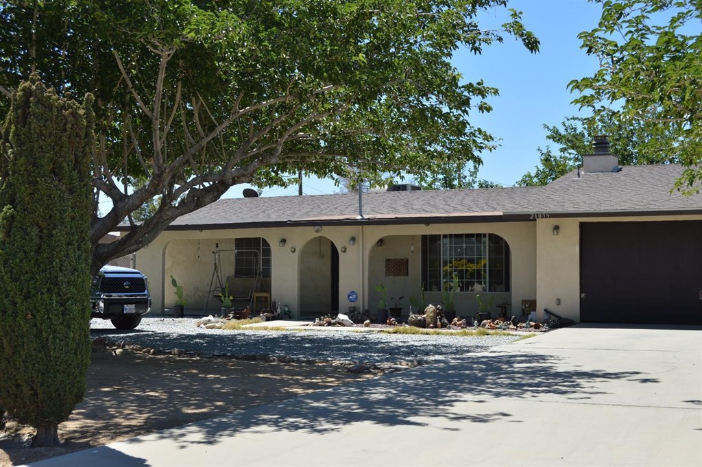 21075 Multnomah Road Apple Valley, CA 92308 - Photo 1 of 1 a front view of a house with a yard