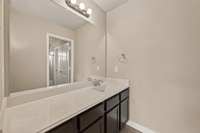 a bathroom with a sink a mirror and a vanity