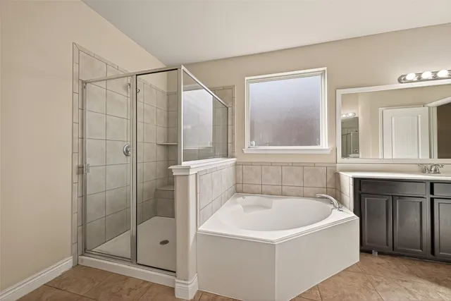 a white bath tub sitting next to a shower