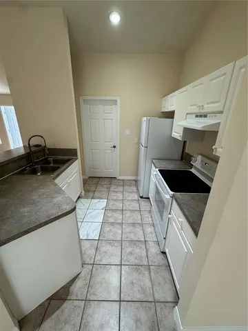 a kitchen with a sink and cabinets