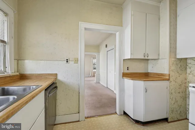 a kitchen with granite countertop a sink and a refrigerator