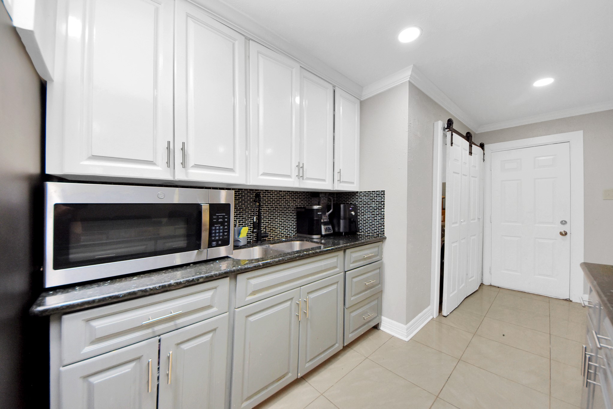 4815 Prairie Ridge Road Houston, TX 77053 - Photo 11 of 44 a kitchen with white cabinets and stainless steel appliances