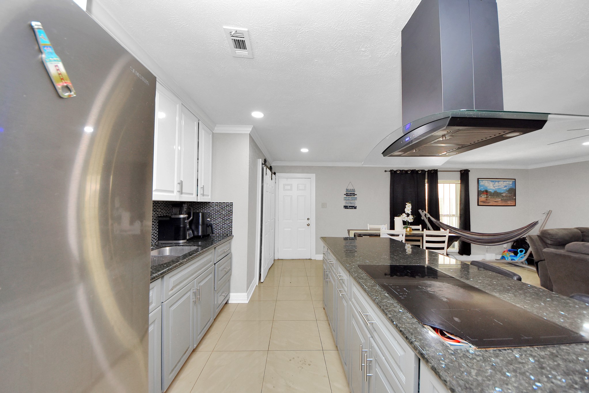 4815 Prairie Ridge Road Houston, TX 77053 - Photo 6 of 44 a large kitchen with kitchen island a large counter top stainless steel appliances and cabinets