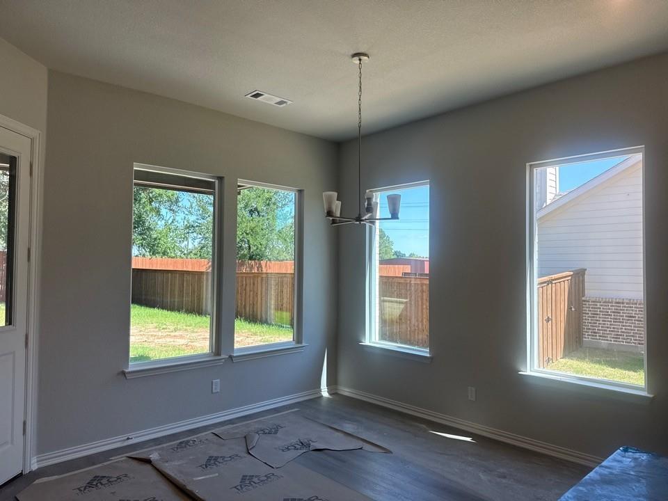 404 Guadalupe Lane Springtown, TX 76082 - Photo 4 of 9 a view of an empty room with a window and wooden floor