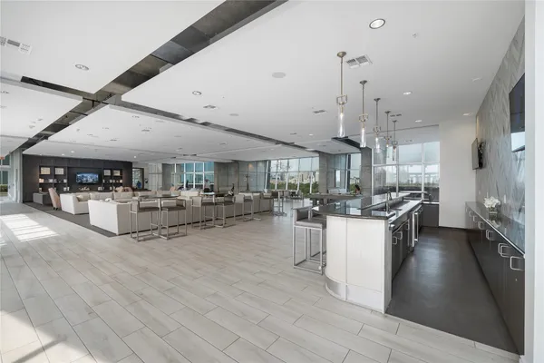 a living room with lots of furniture and kitchen view