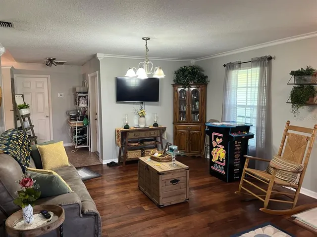 a living room with furniture and a chandelier