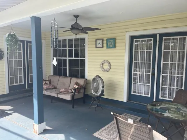 a kitchen with stainless steel appliances wooden floor and chandelier