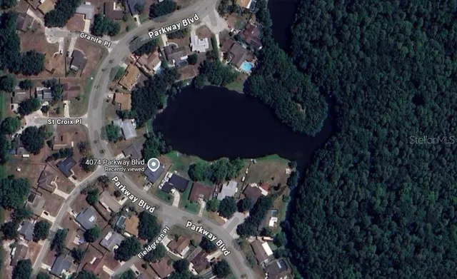 a view of a swimming pool with outdoor seating and plants