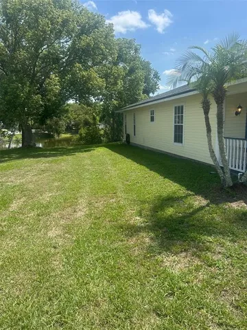 a backyard of a house with table and chairs