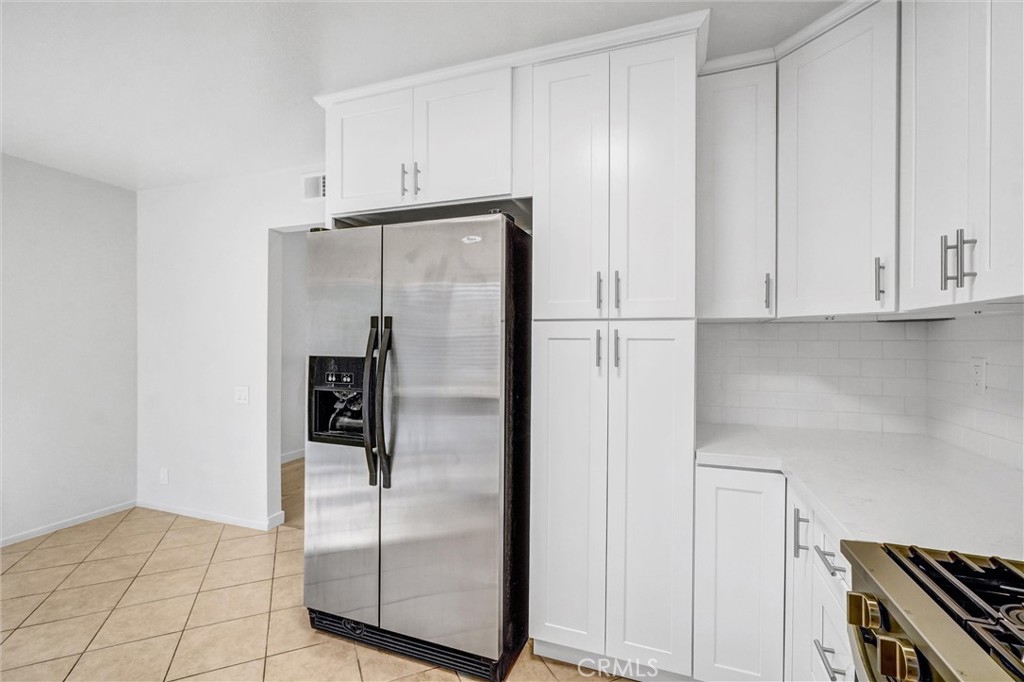 27122 Valleymont Road Lake Forest, CA 92630 - Photo 11 of 35 a kitchen with metallic refrigerator freezer and a dishwasher