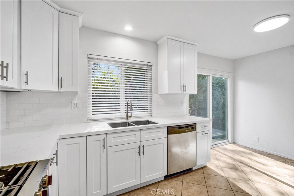 27122 Valleymont Road Lake Forest, CA 92630 - Photo 12 of 35 a kitchen with granite countertop white cabinets and white appliances