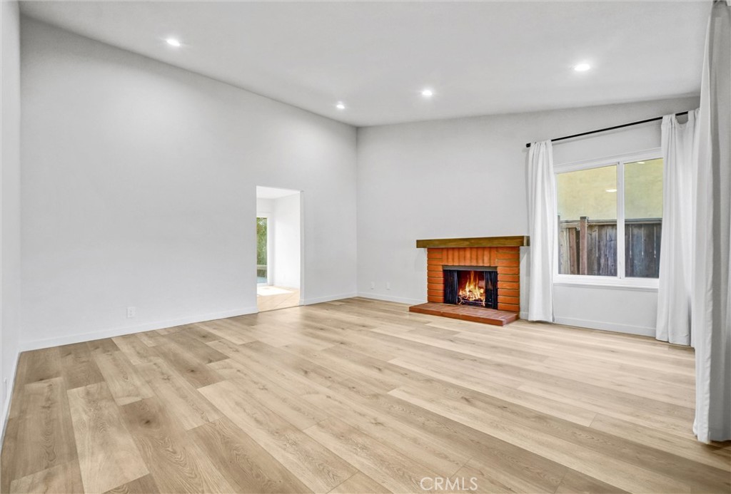 27122 Valleymont Road Lake Forest, CA 92630 - Photo 7 of 35 a view of an empty room with a window and fireplace