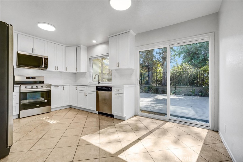 27122 Valleymont Road Lake Forest, CA 92630 - Photo 9 of 35 a kitchen with a stove a sink and a refrigerator