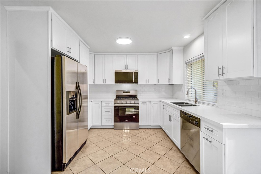 27122 Valleymont Road Lake Forest, CA 92630 - Photo 10 of 35 a kitchen with stainless steel appliances granite countertop a stove a sink and a refrigerator