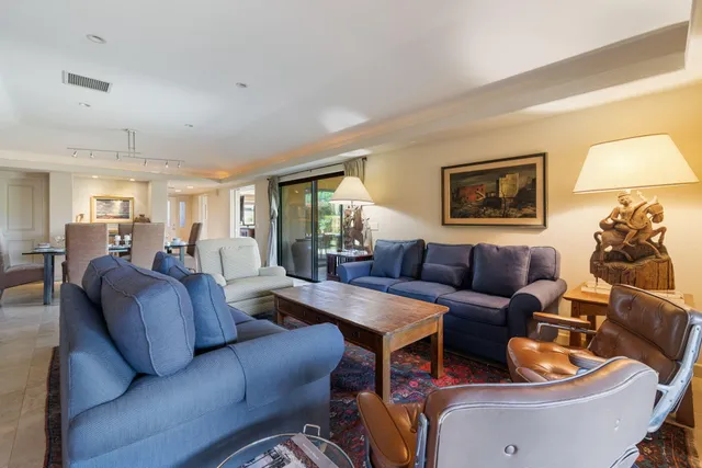 a living room with furniture and a lamp