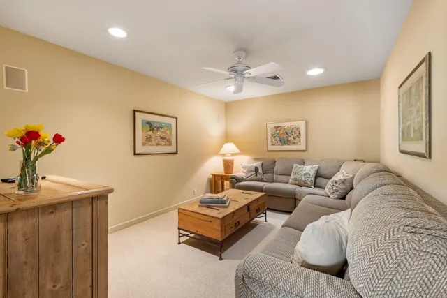 a living room with furniture a chandelier and a window
