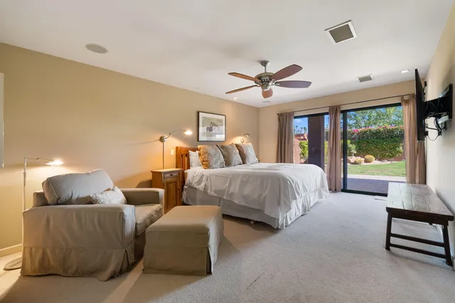 a spacious bedroom with two beds and a large window