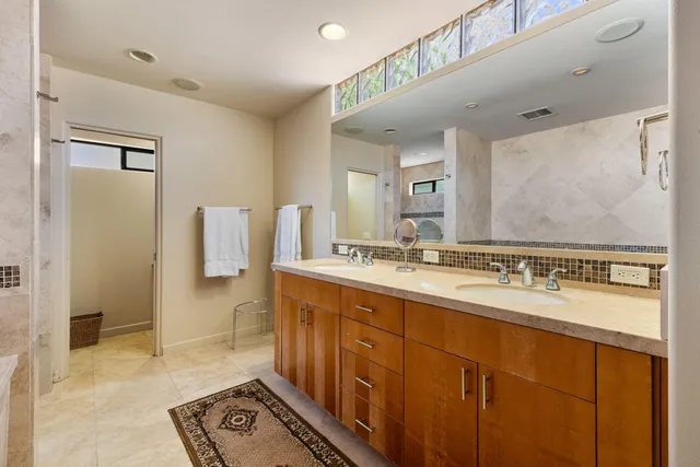a bathroom with a sink mirror and a shower