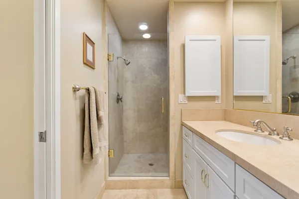 a bathroom with a granite countertop sink and a mirror