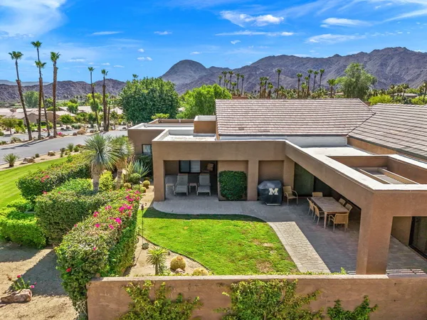 a view of a swimming pool with a patio and a yard
