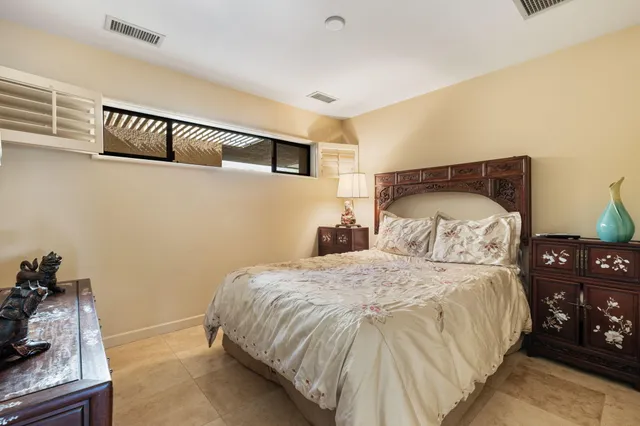 a bedroom with a bed and a night stand