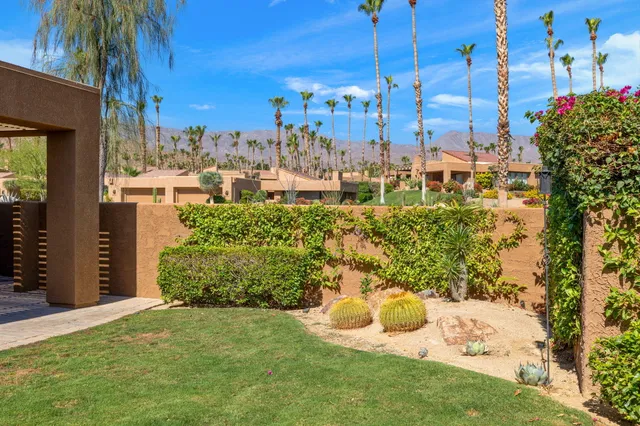 a view of a city that has lawn chairs under an umbrella