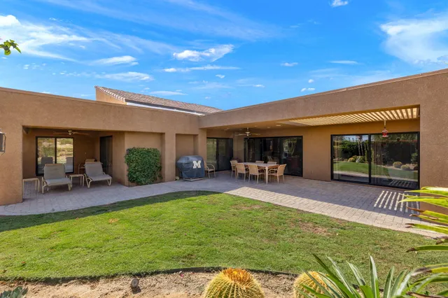 a swimming pool with outdoor seating and yard