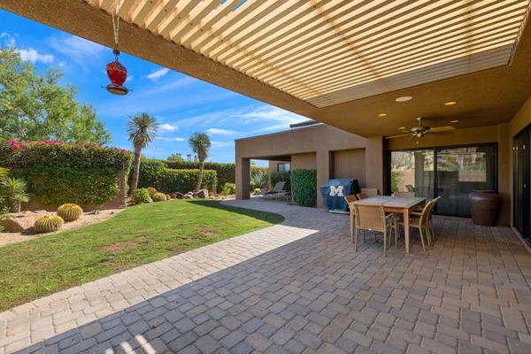 a view of a backyard with plants and a patio