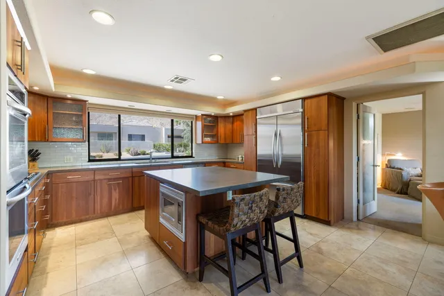 a kitchen with granite countertop a sink and a refrigerator