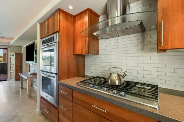 a stove top oven sitting inside of a kitchen
