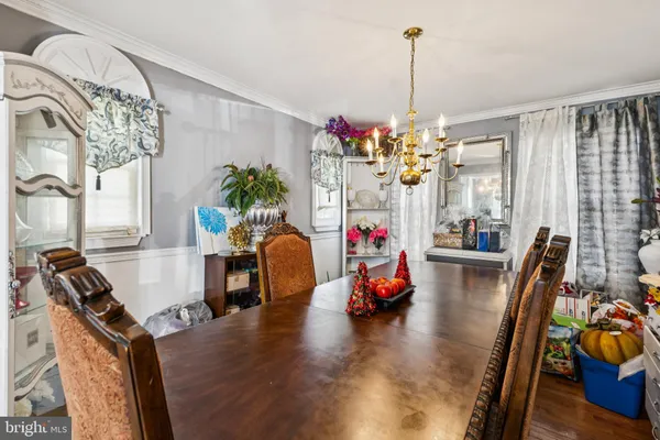 a view of a dining room with furniture and a chandelier