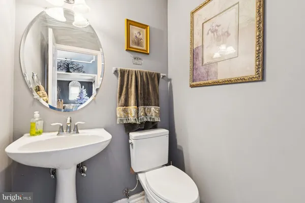 a bathroom with a toilet a sink and a mirror
