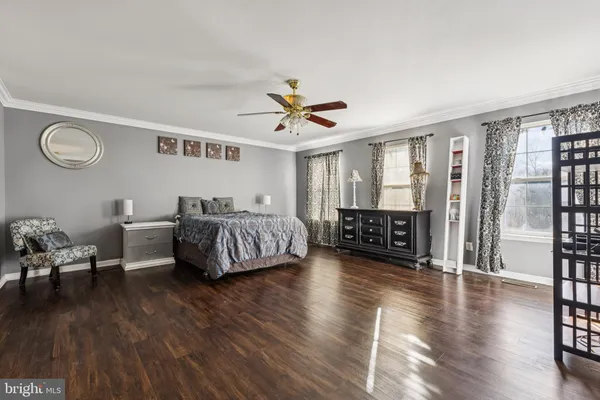 a living room with furniture and a table with wooden floor