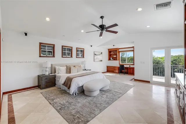 a spacious bedroom with a bed a couch and a window