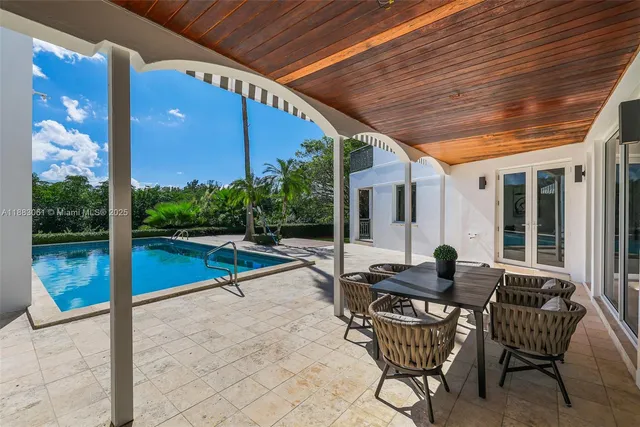 a swimming pool with outdoor seating and yard