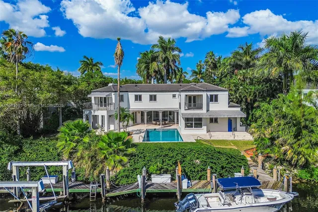 a view of a house with balcony and trees al around