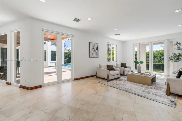 a living room with furniture and large windows