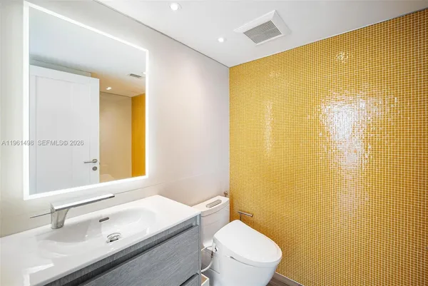 a bathroom with a sink a toilet and shower curtain