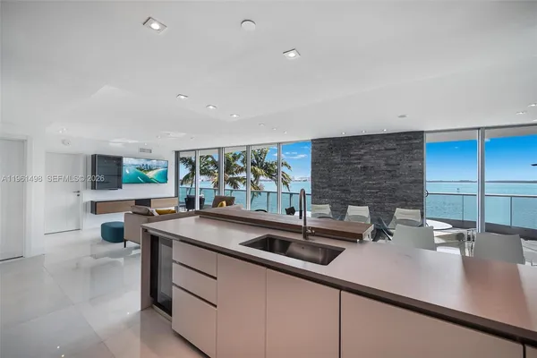a kitchen with stainless steel appliances granite countertop a sink and a stove