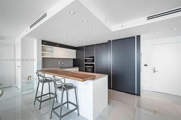 a kitchen that has a cabinets and a refrigerator